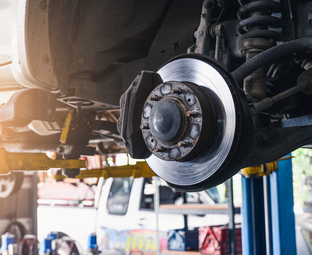 Brake rotor on a vehicle in a service bay