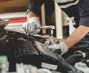 Technician repairing an engine
