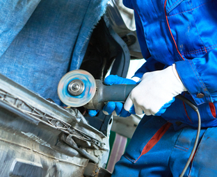 Auto body technician repairing a vehicle panel